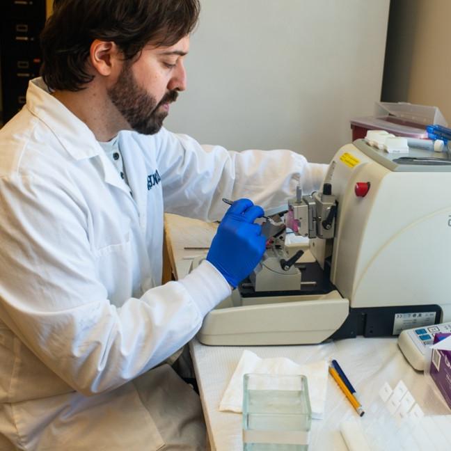 A research student uses lab equipment